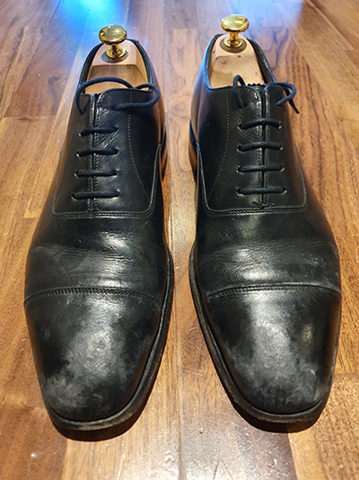 Pair of water-stained, black Loake's